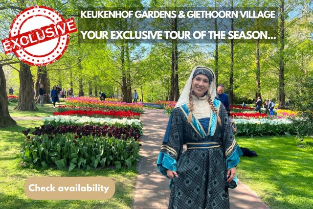 A Woman In A Holland Dress Posing For A Picture In The Keukenhof Tulip Gardens